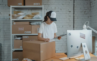 A woman is packing a delivery boxes