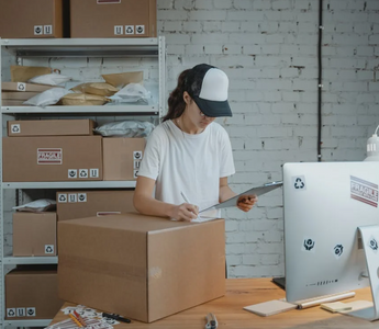 A woman is packing a delivery boxes