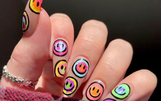 A girl showing her manicure with stickers printed by phomemo label maker.