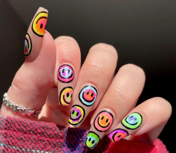 A girl showing her manicure with stickers printed by phomemo label maker.