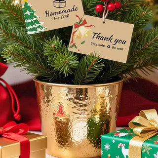 Phomemo mini pocket printer next to wrapped Christmas presents and holiday decorations