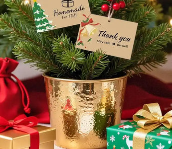 Phomemo mini pocket printer next to wrapped Christmas presents and holiday decorations