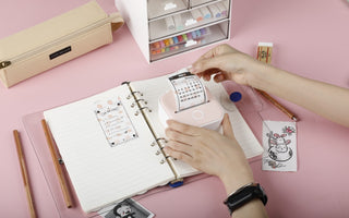 A girl studying with her study schedule and print it with phomemo t02 mini printer.