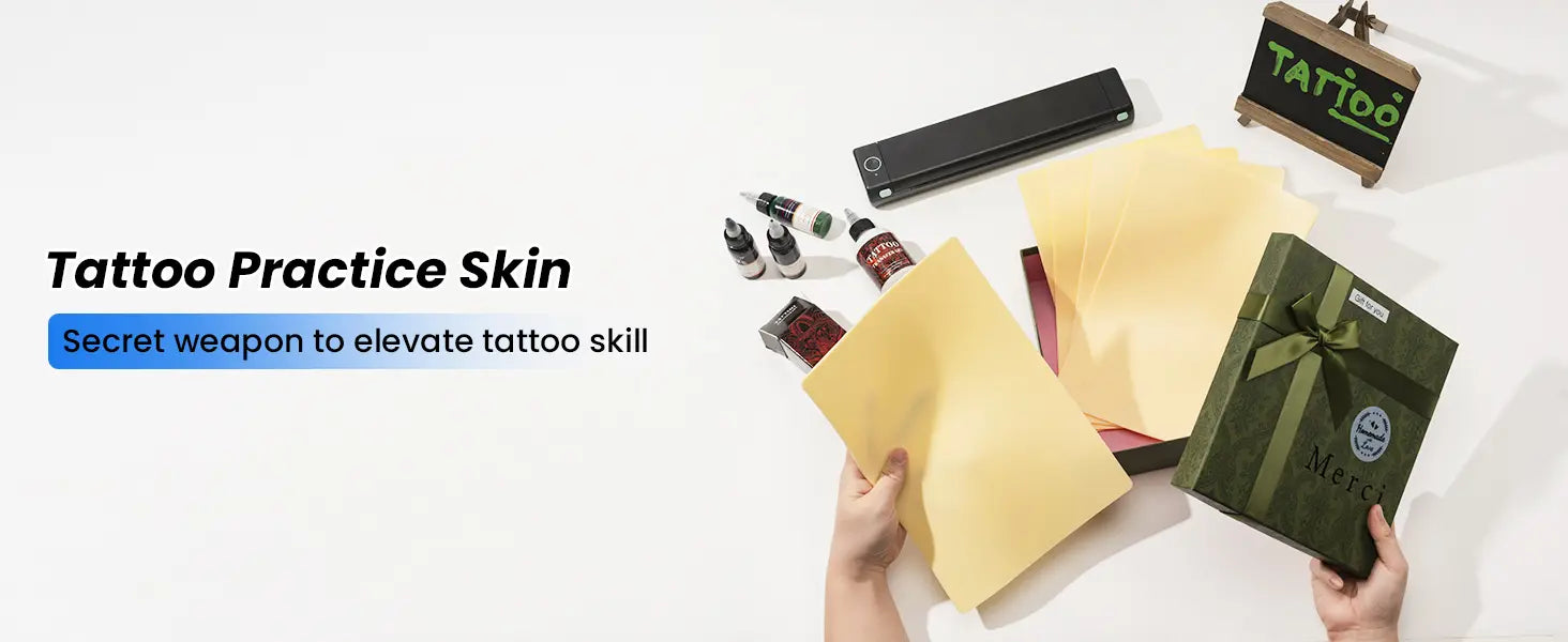 Hands holding tattoo practice skin sheets with tattoo inks, stencil printer & gift box in the background, ideal for improving tattoo skills